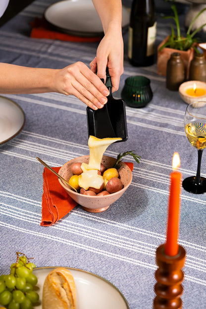 melting cheese over potatoes